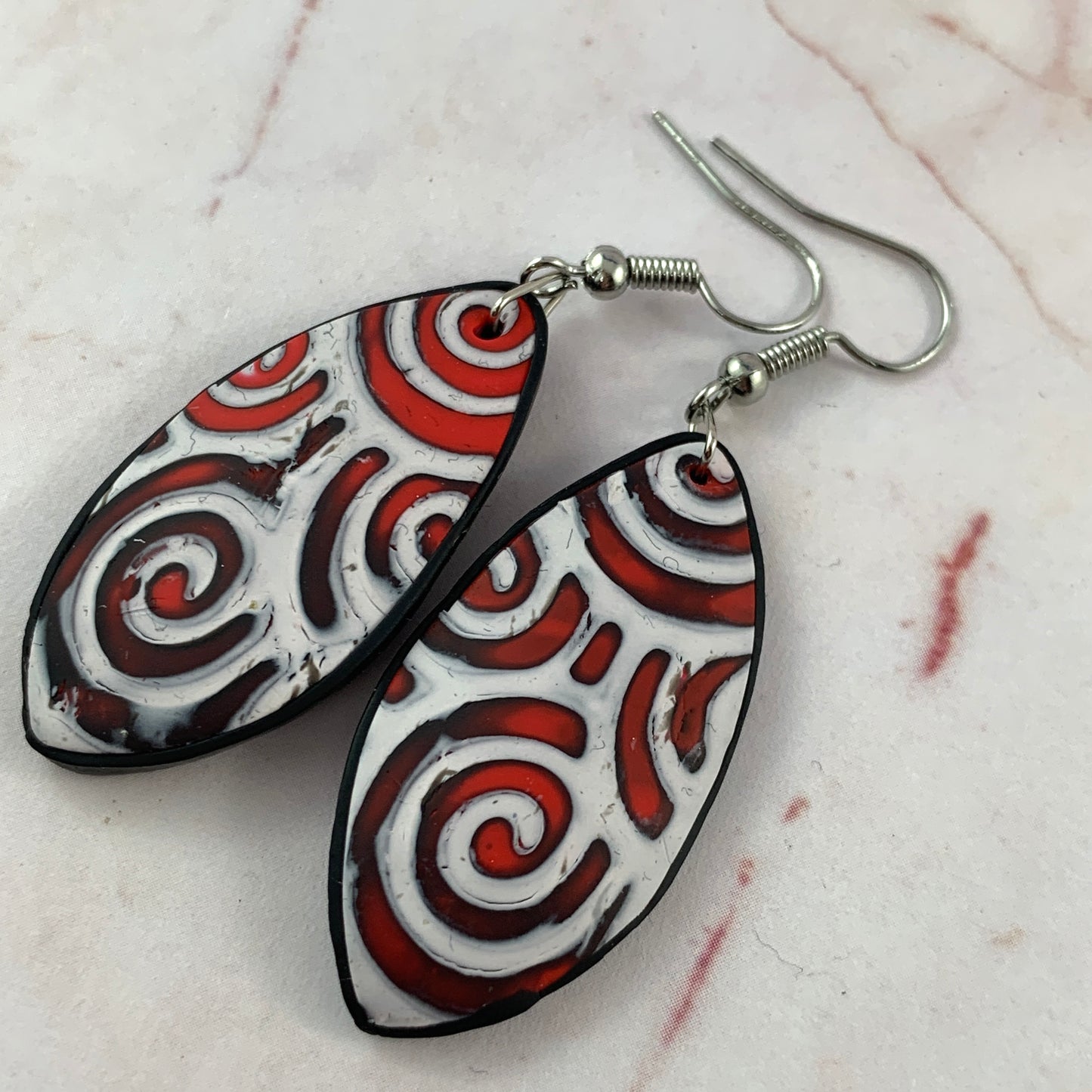 Handmade red and white swirl teardrop statement earrings with silver hooks