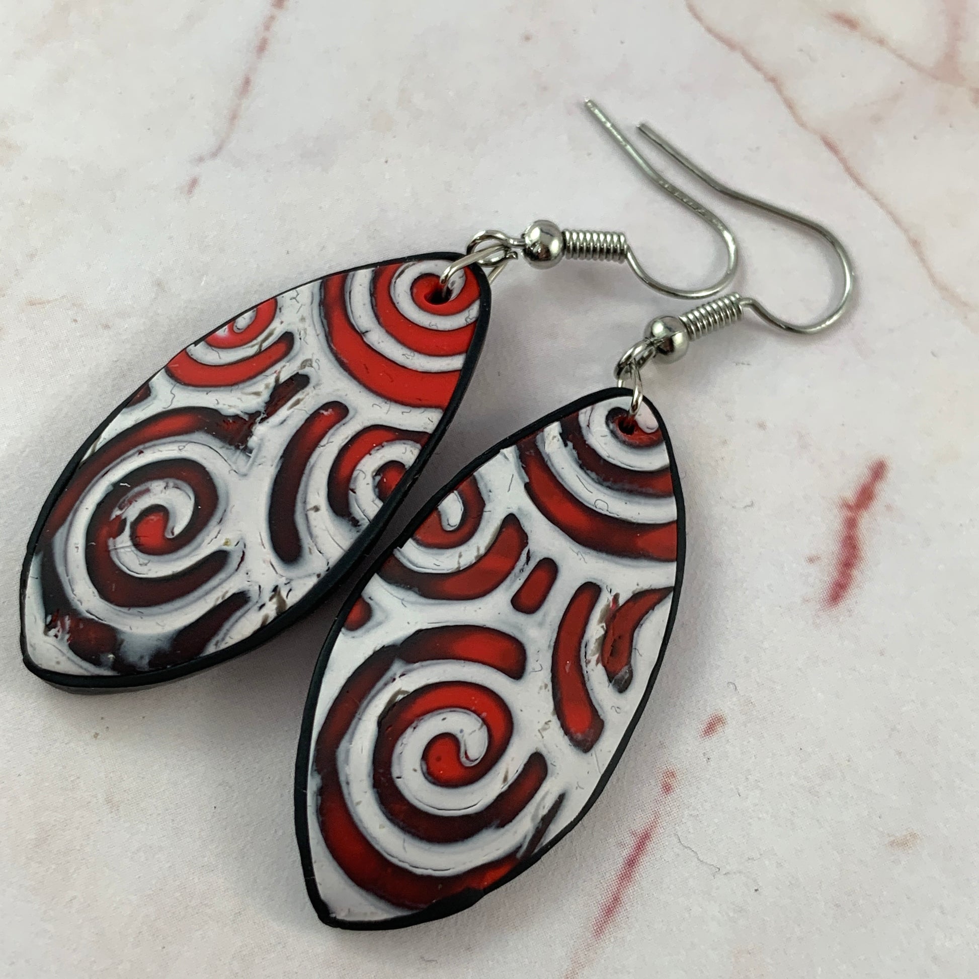 Handmade red and white swirl teardrop statement earrings with silver hooks