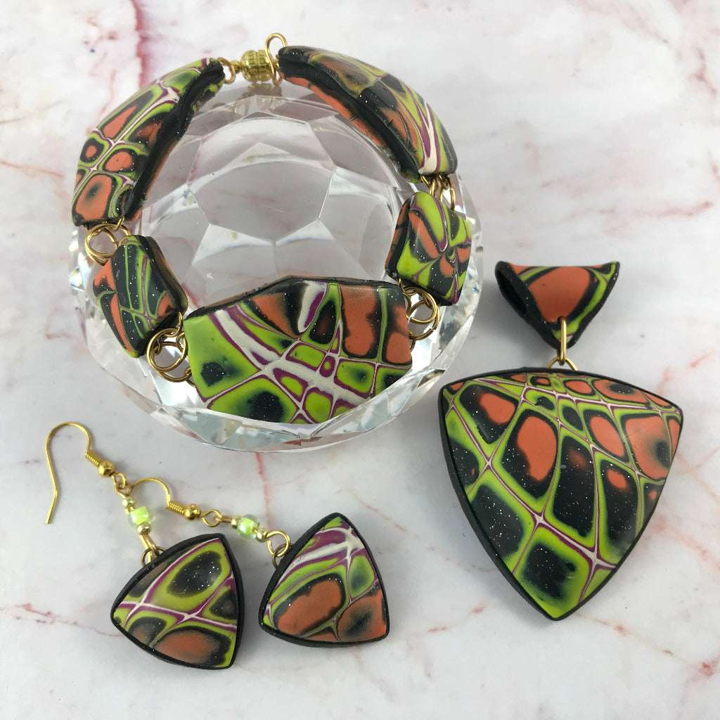 Statement polymer clay jewellery set with bold orange green and black design, including pendant necklace, earrings and bracelet, handcrafted one of a kind jewellery Australia