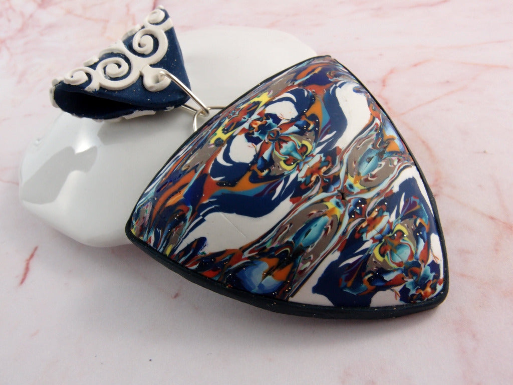 Large close-up of blue and white abstract pendant showing front view, side angle, and detailed marbled pattern.